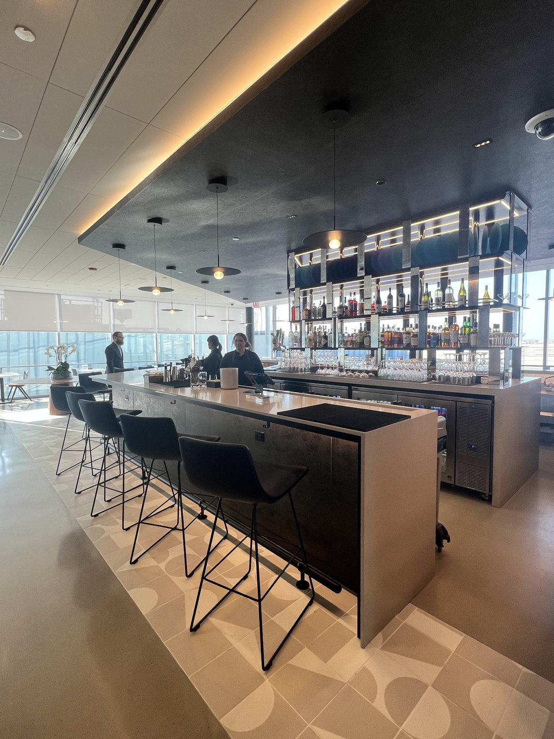 a bar with a counter and chairs