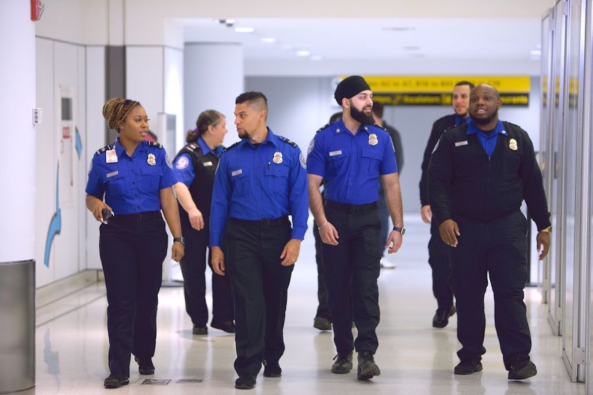 a group of police officers walking in a hallway