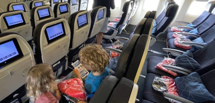 a group of children sitting in an airplane