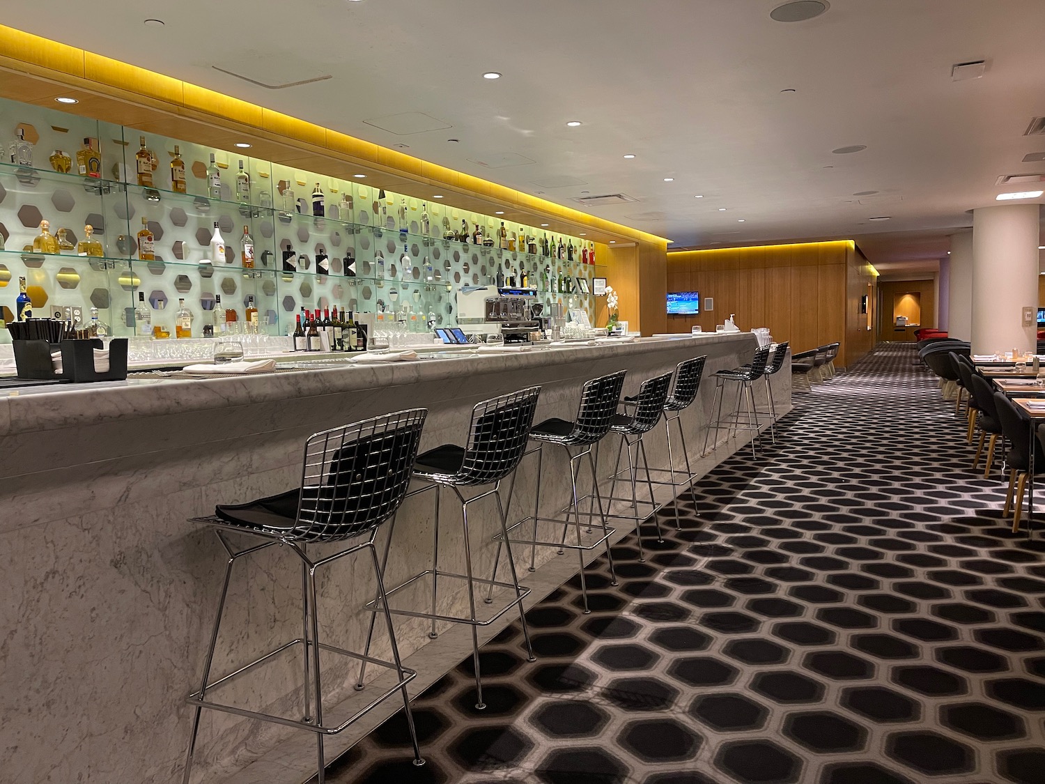 a bar with chairs and shelves in a room