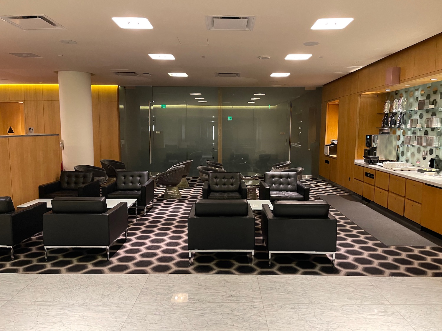 a room with black chairs and a white counter