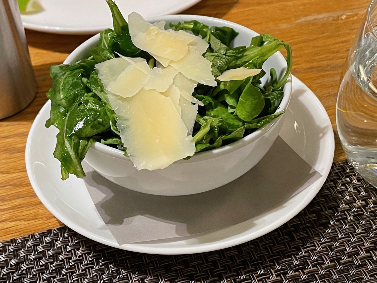 a bowl of salad with cheese on top