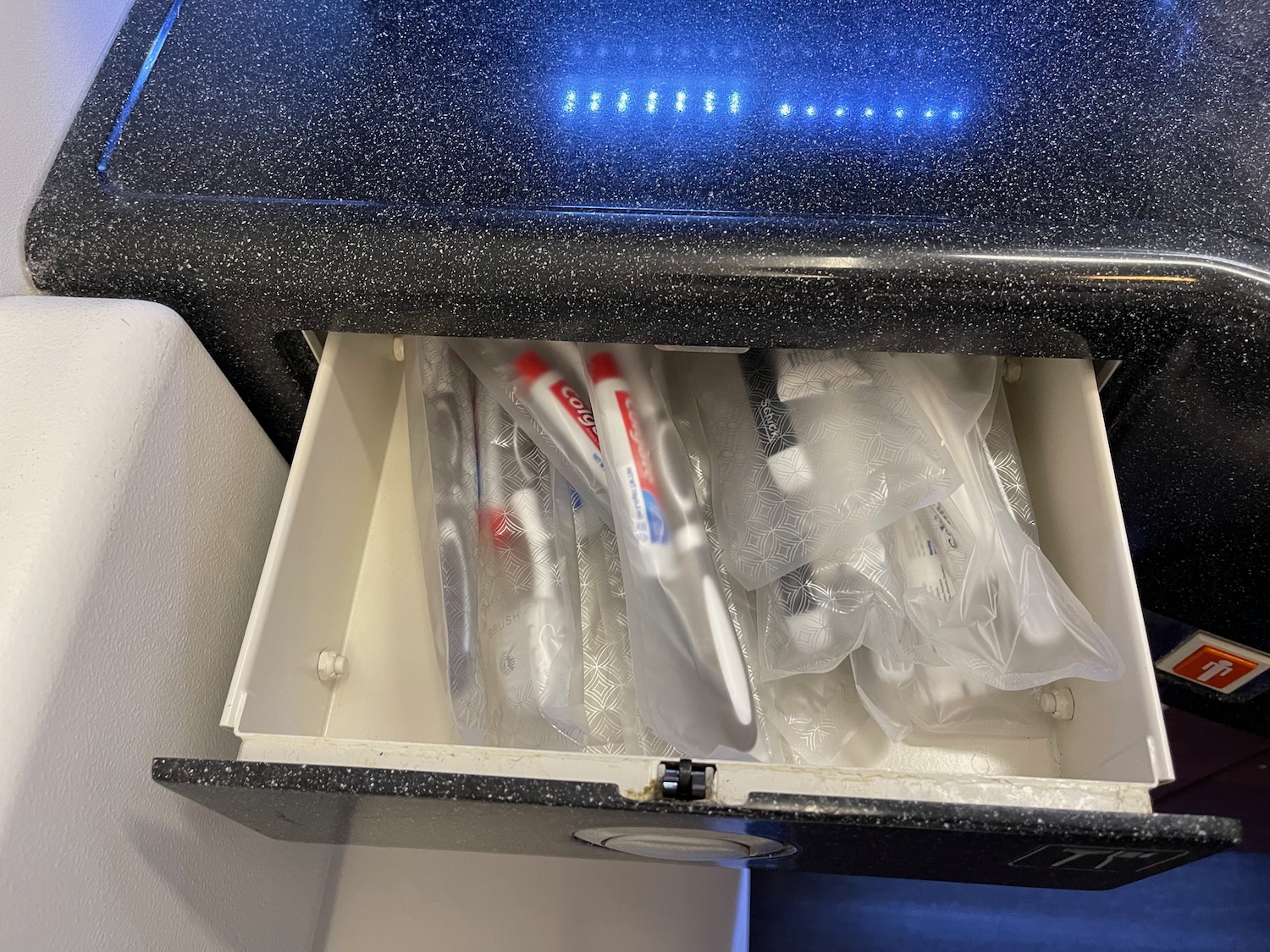 a drawer with toothbrushes in it