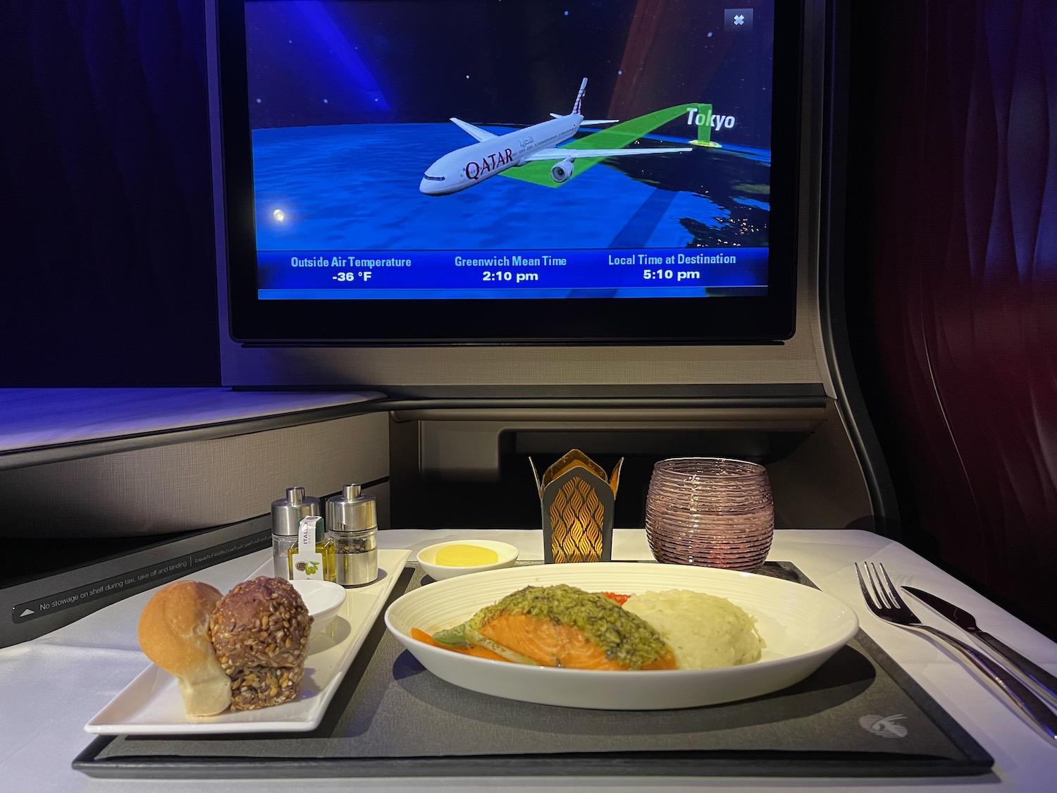 a plate of food on a table with a television