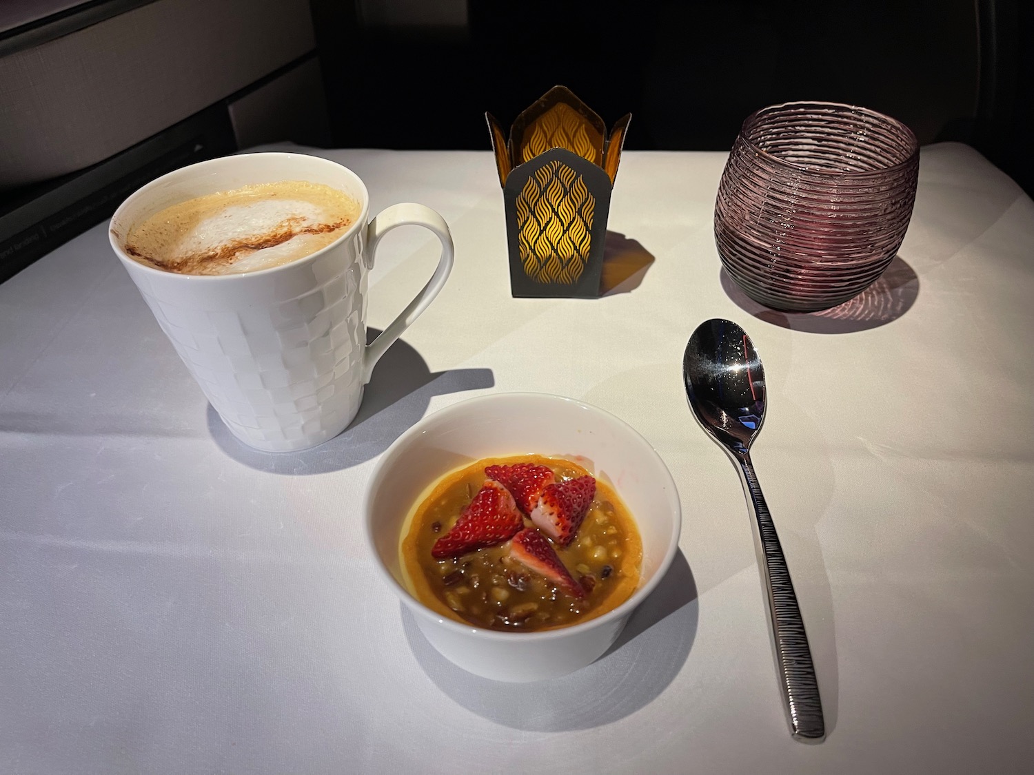 a bowl of food and a spoon on a table