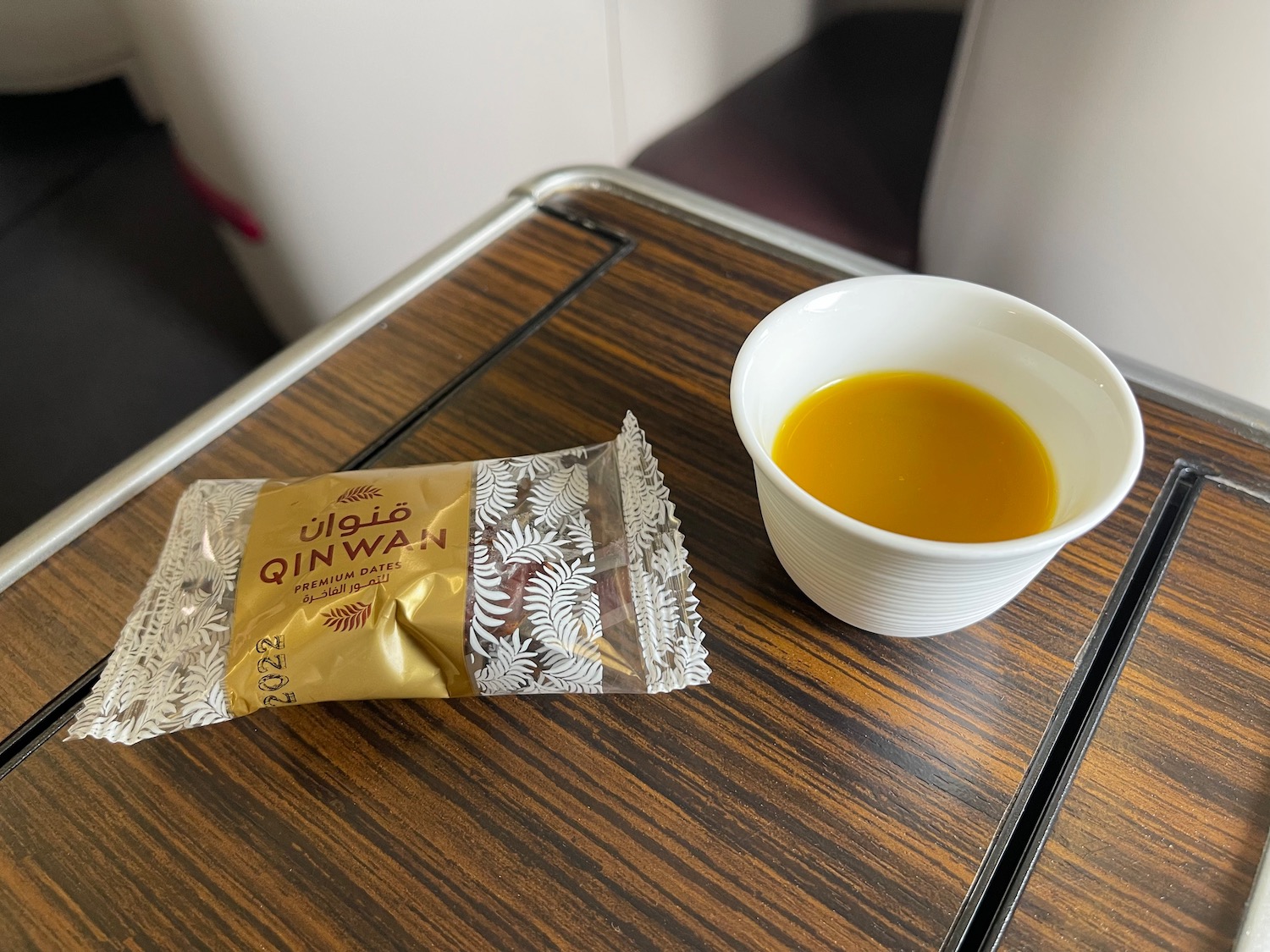 a bowl of liquid and a packet of liquid on a table