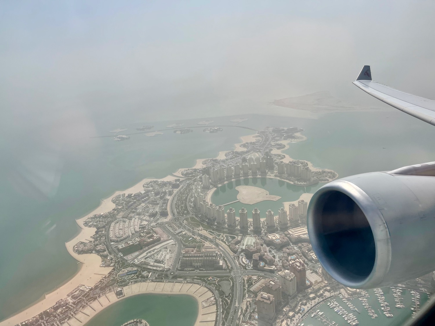 an airplane wing and wing of an airplane flying over a city