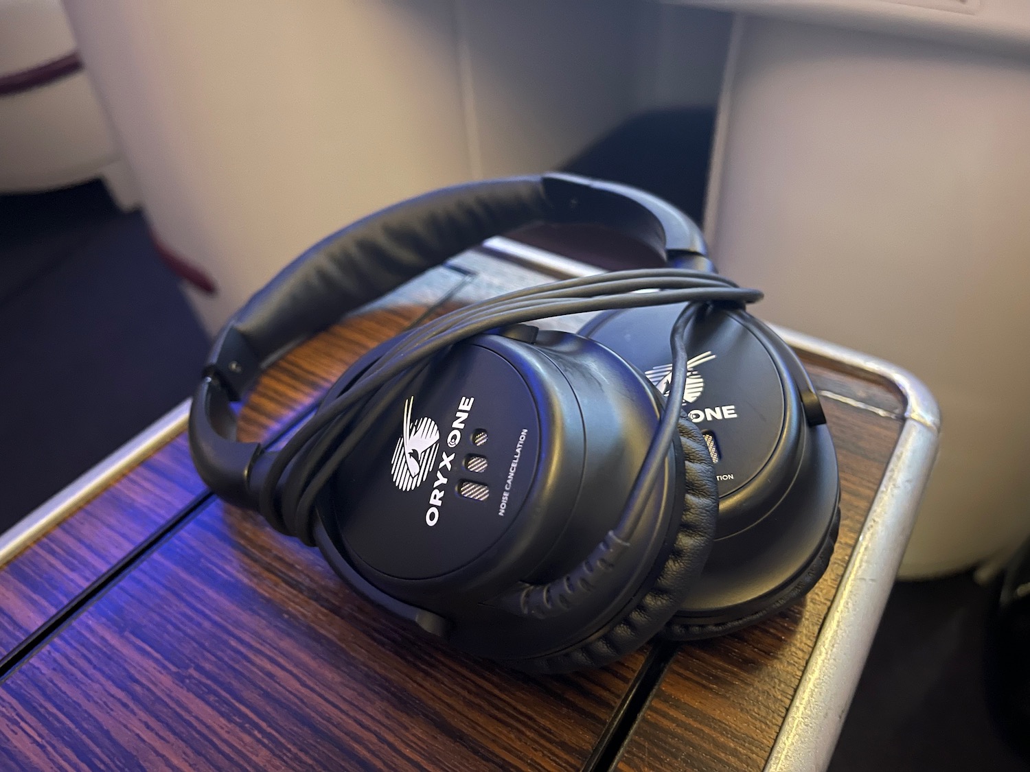 a pair of black headphones on a wood surface