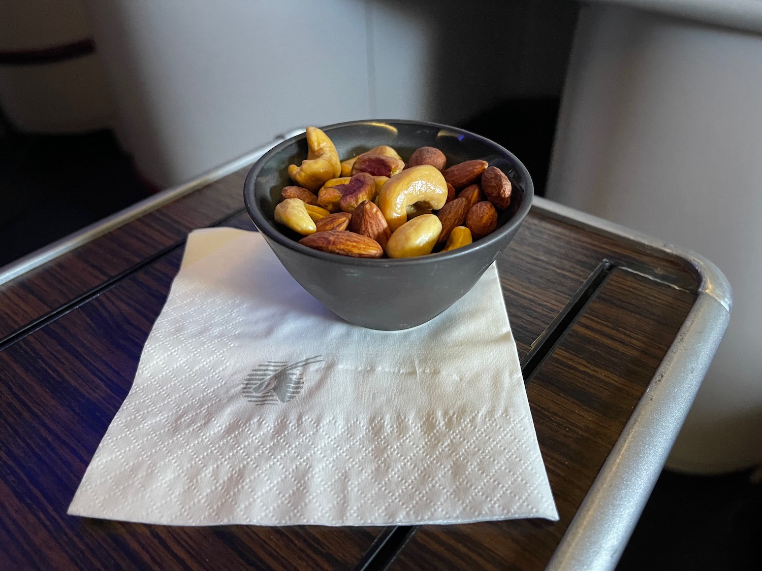 a bowl of nuts on a napkin