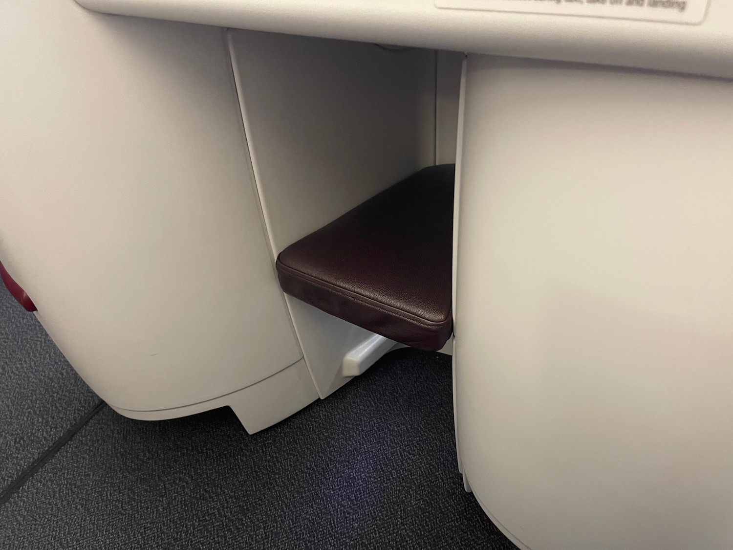 a black seat under a white table