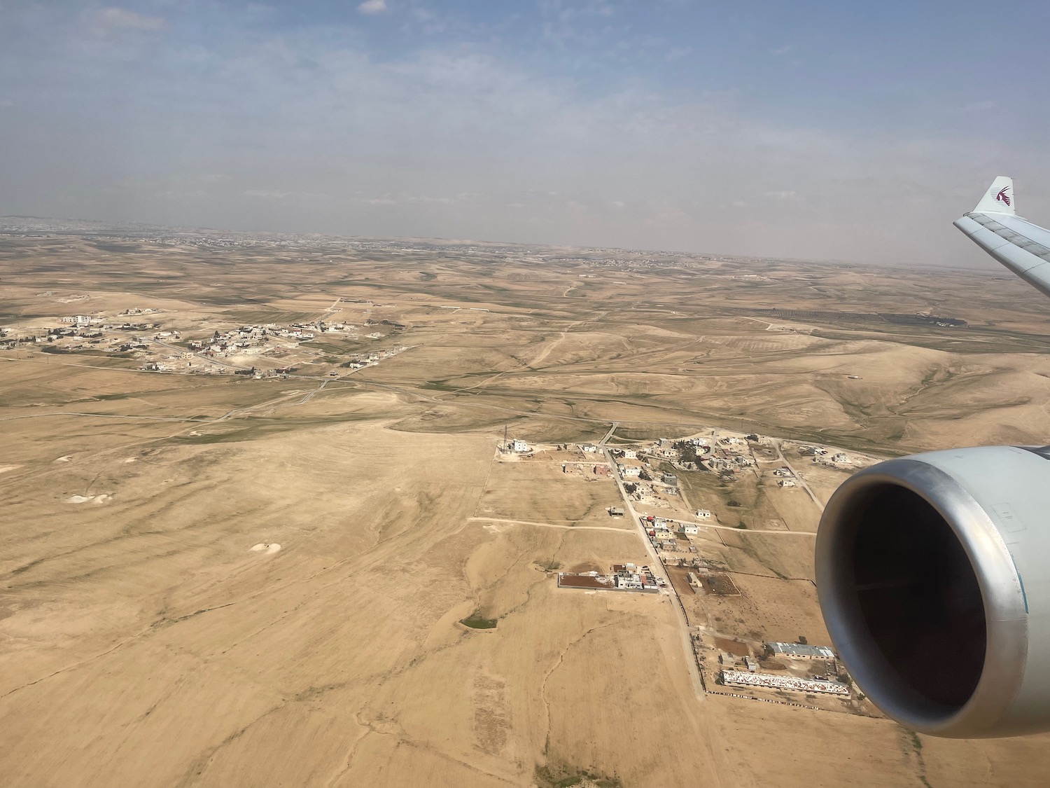 an airplane wing over a landscape