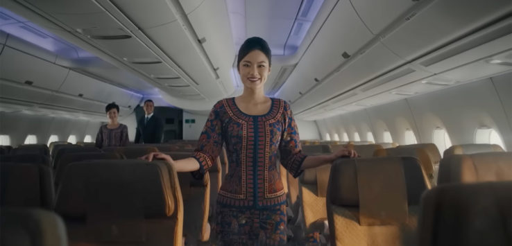 a woman standing in an airplane