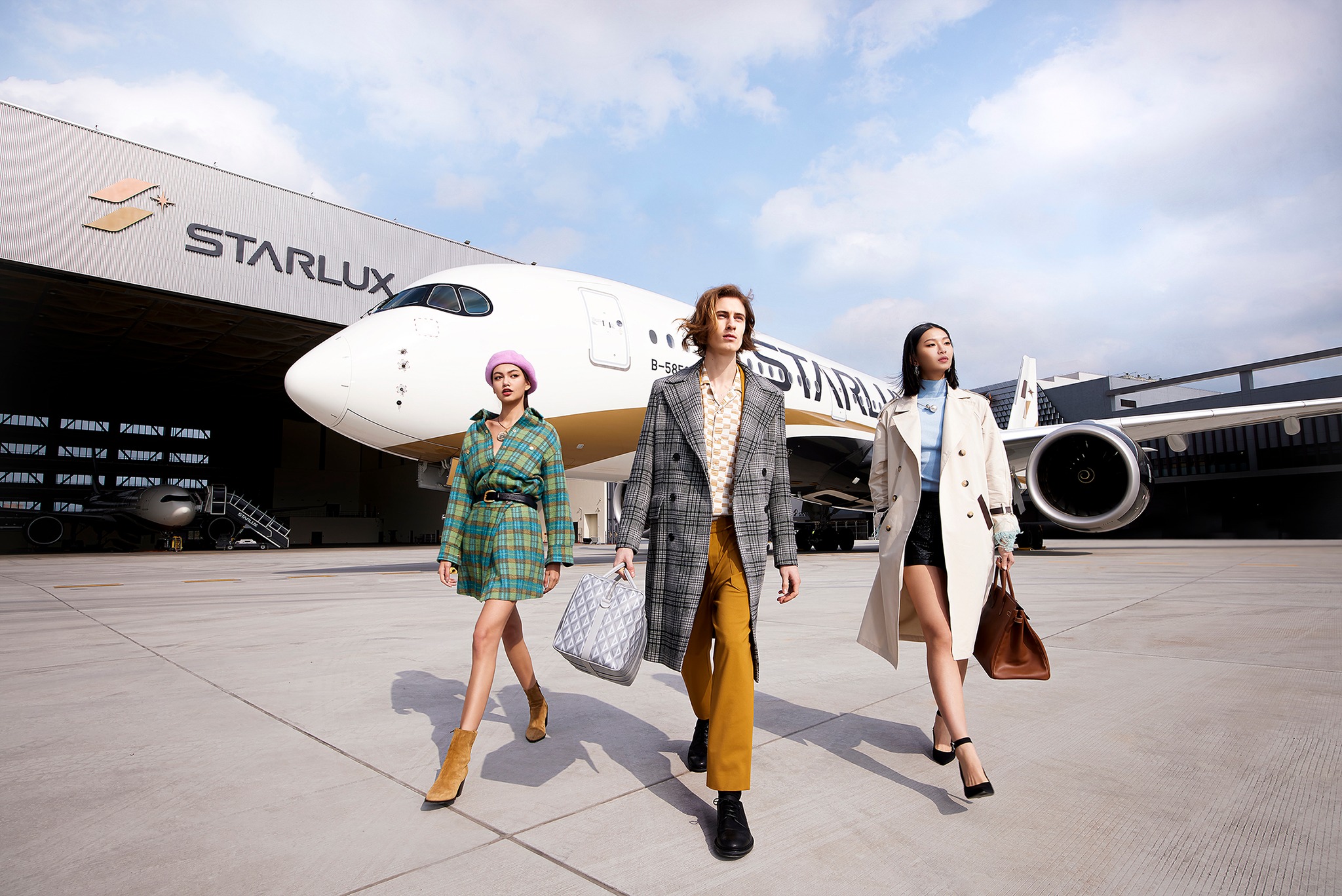 a group of people walking in front of an airplane