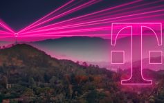 a pink light trails over a mountain