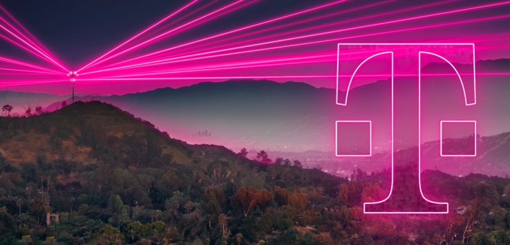 a pink light trails over a mountain