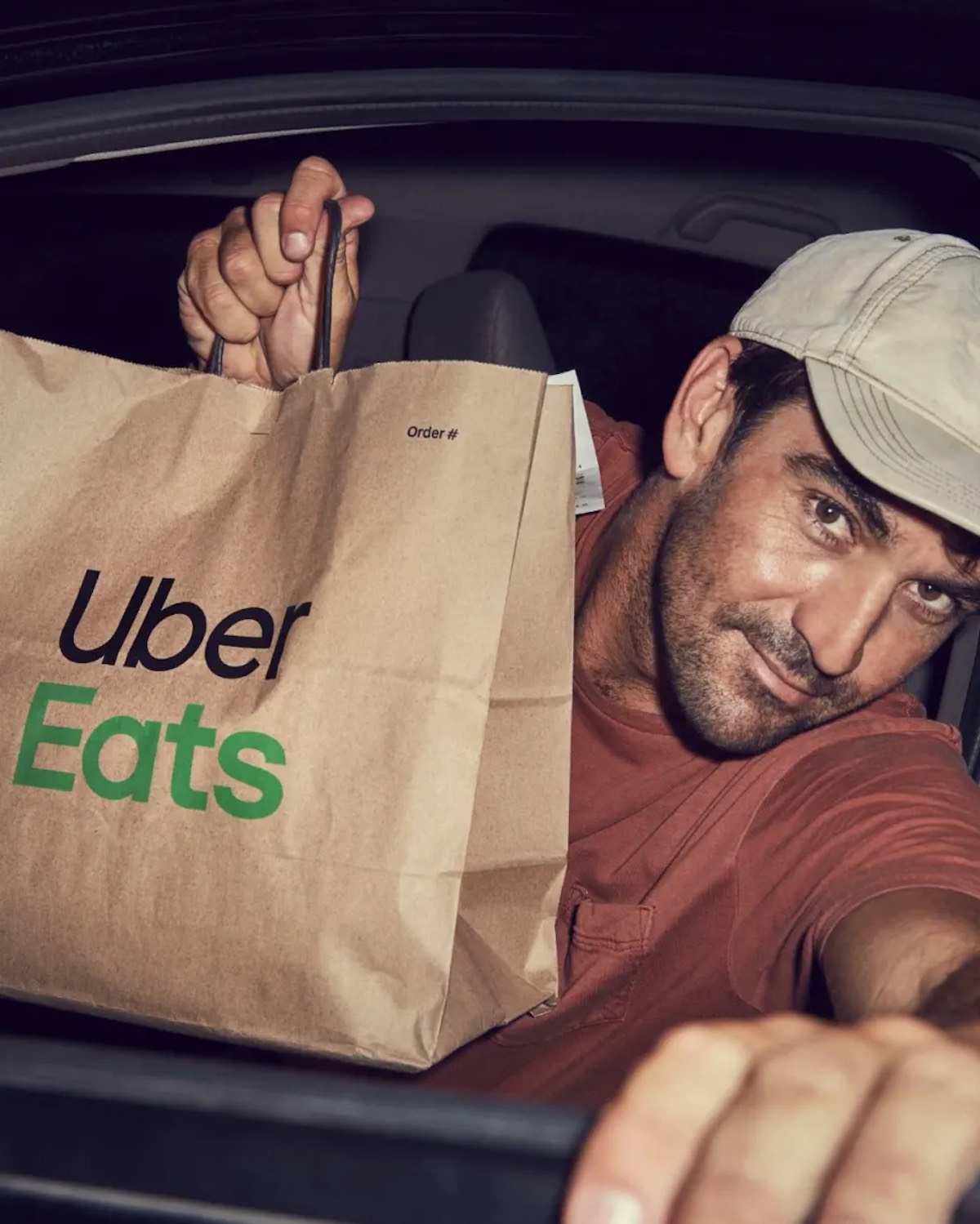 a man in a car holding a bag