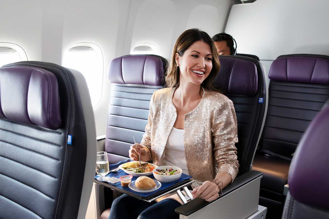 a woman sitting in a chair with a tray of food