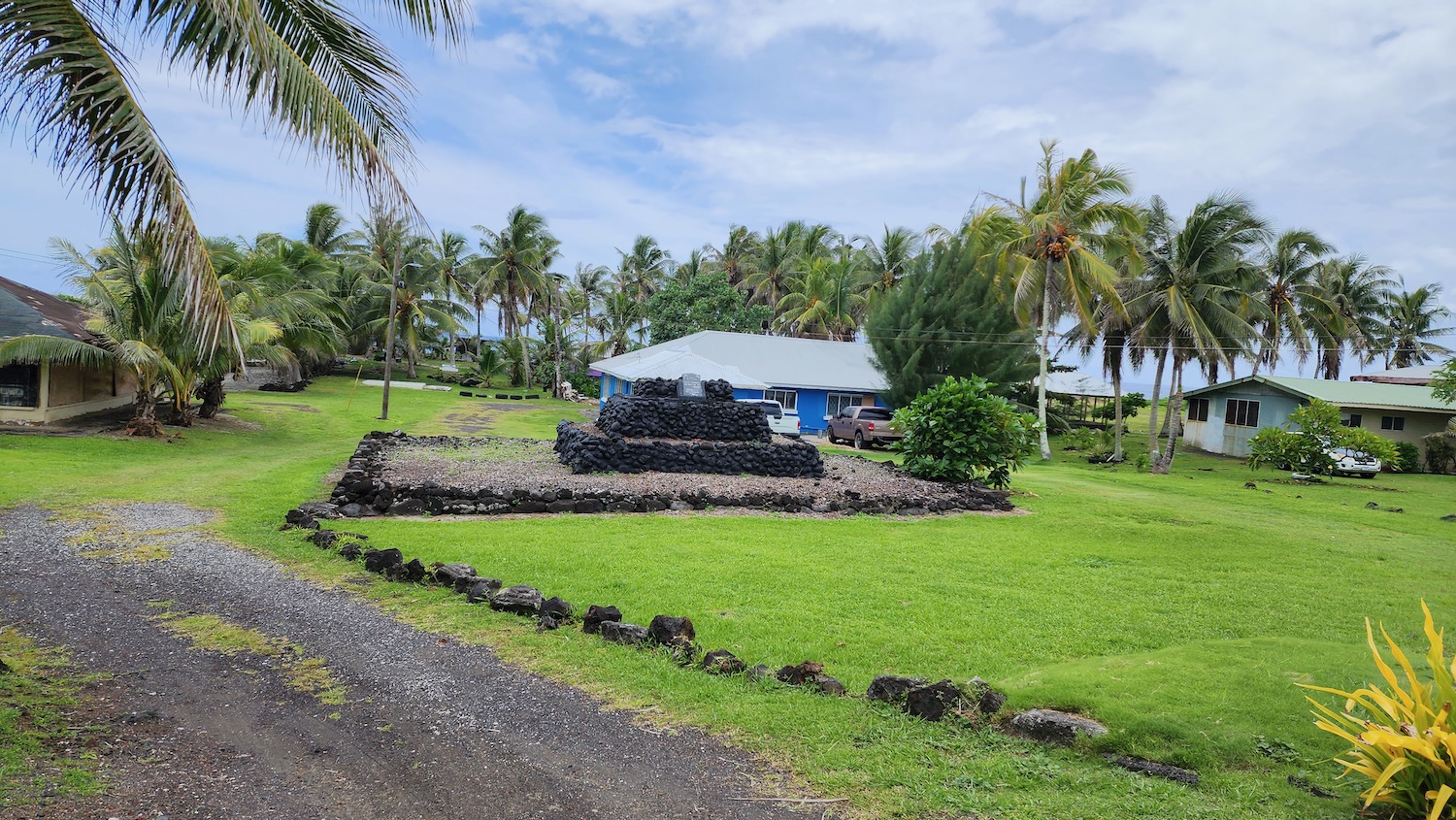 a house with palm trees and a blue building