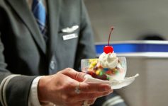 a person holding a dish of ice cream