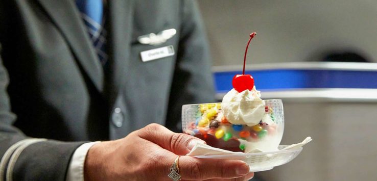 a person holding a dish of ice cream