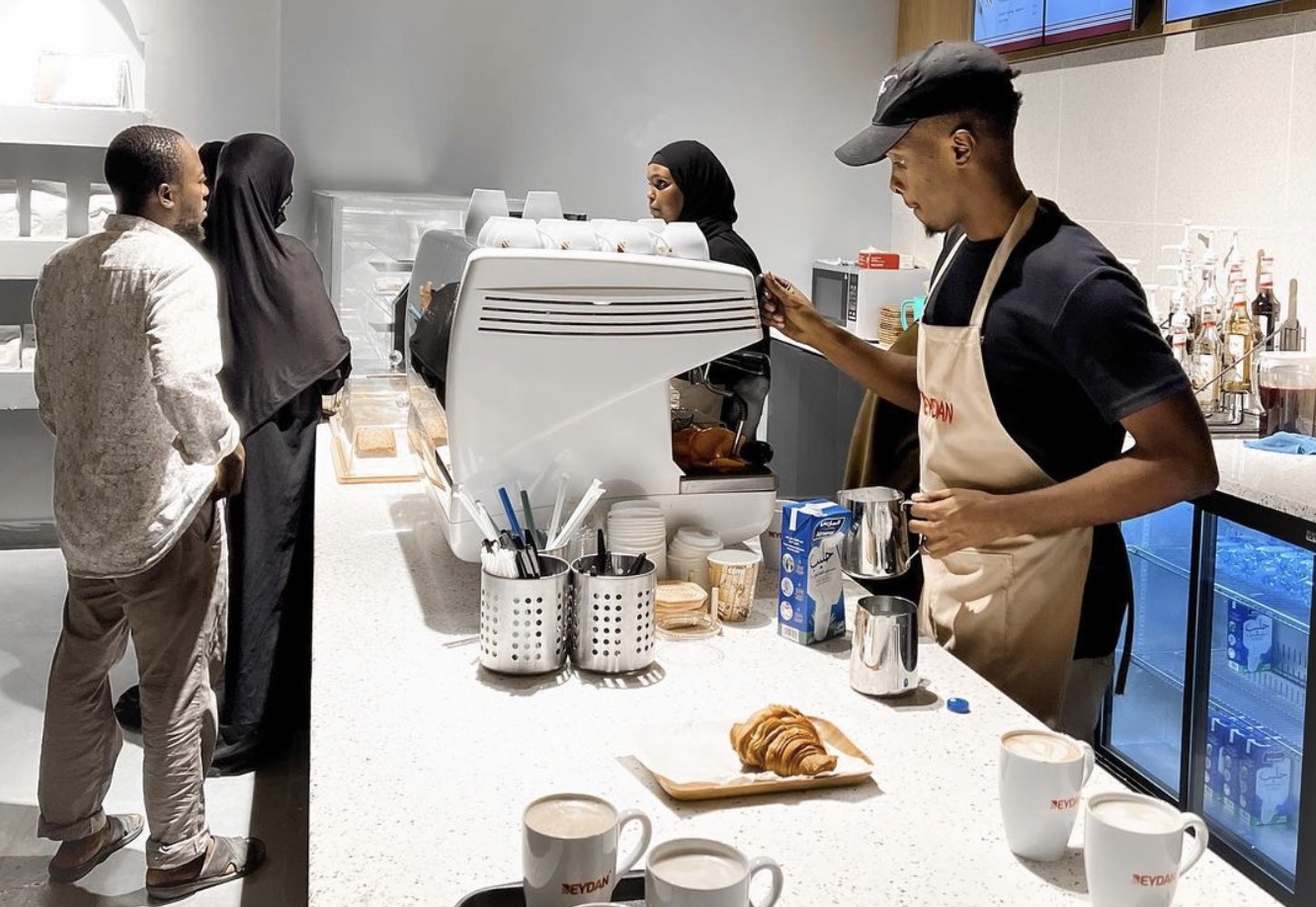 a group of people standing around a counter