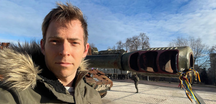 a man taking a selfie with a tank