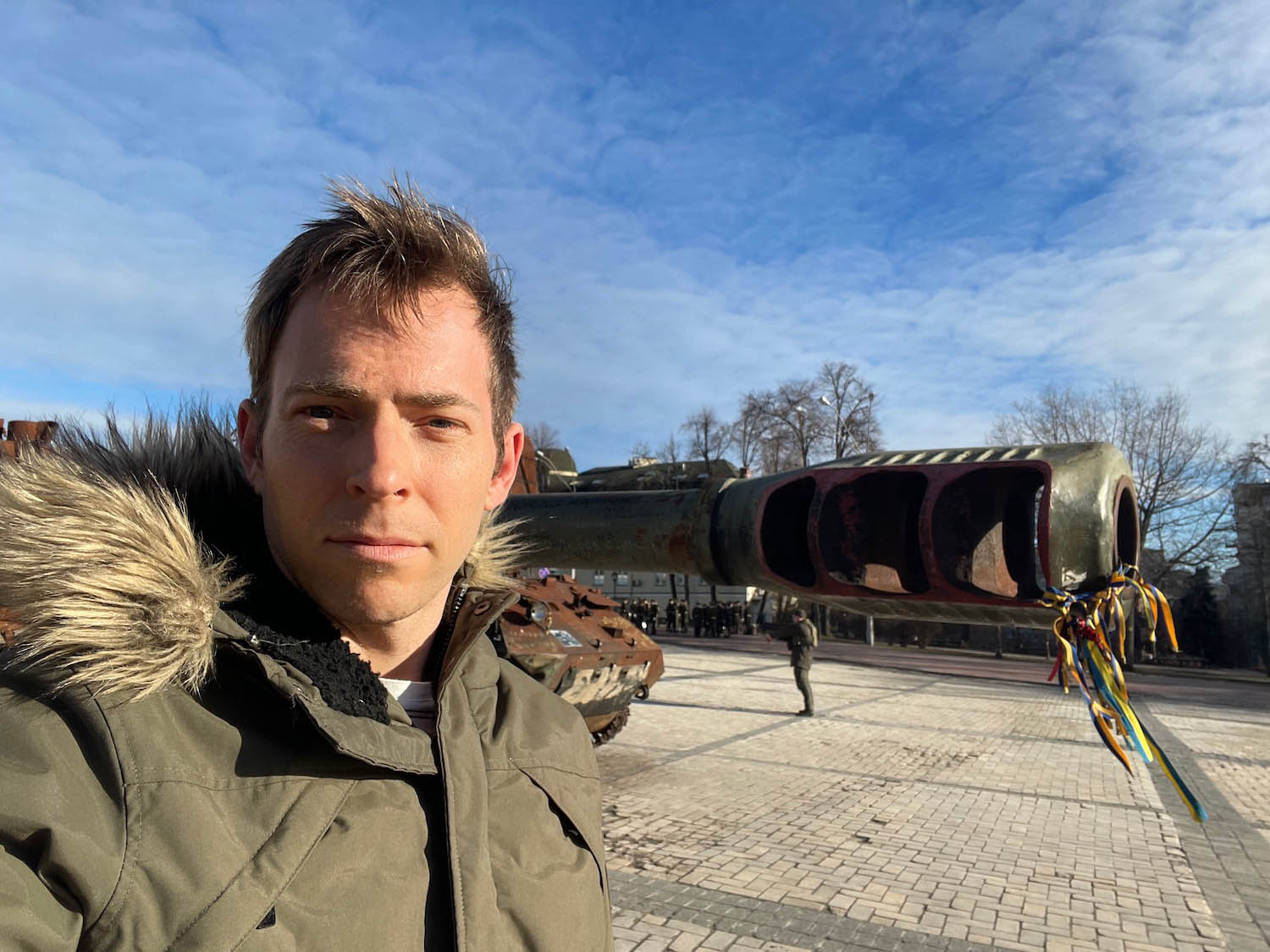 a man taking a selfie with a tank