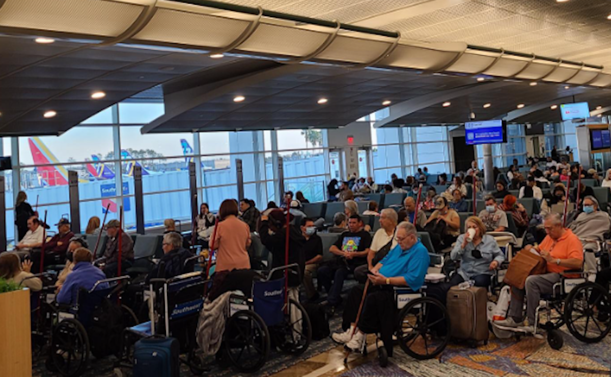 a group of people in a room with chairs and a large window