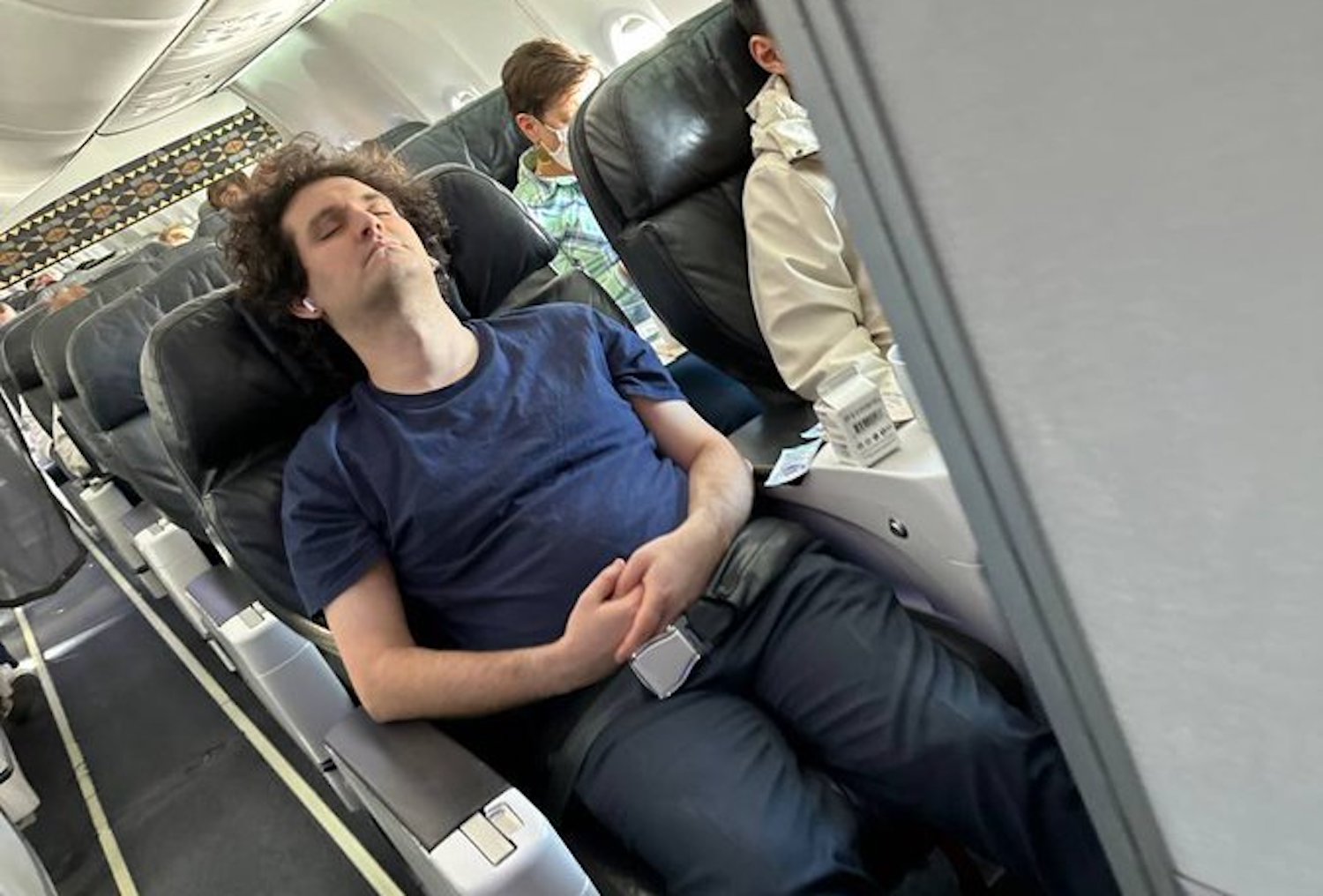 a man sleeping on an airplane