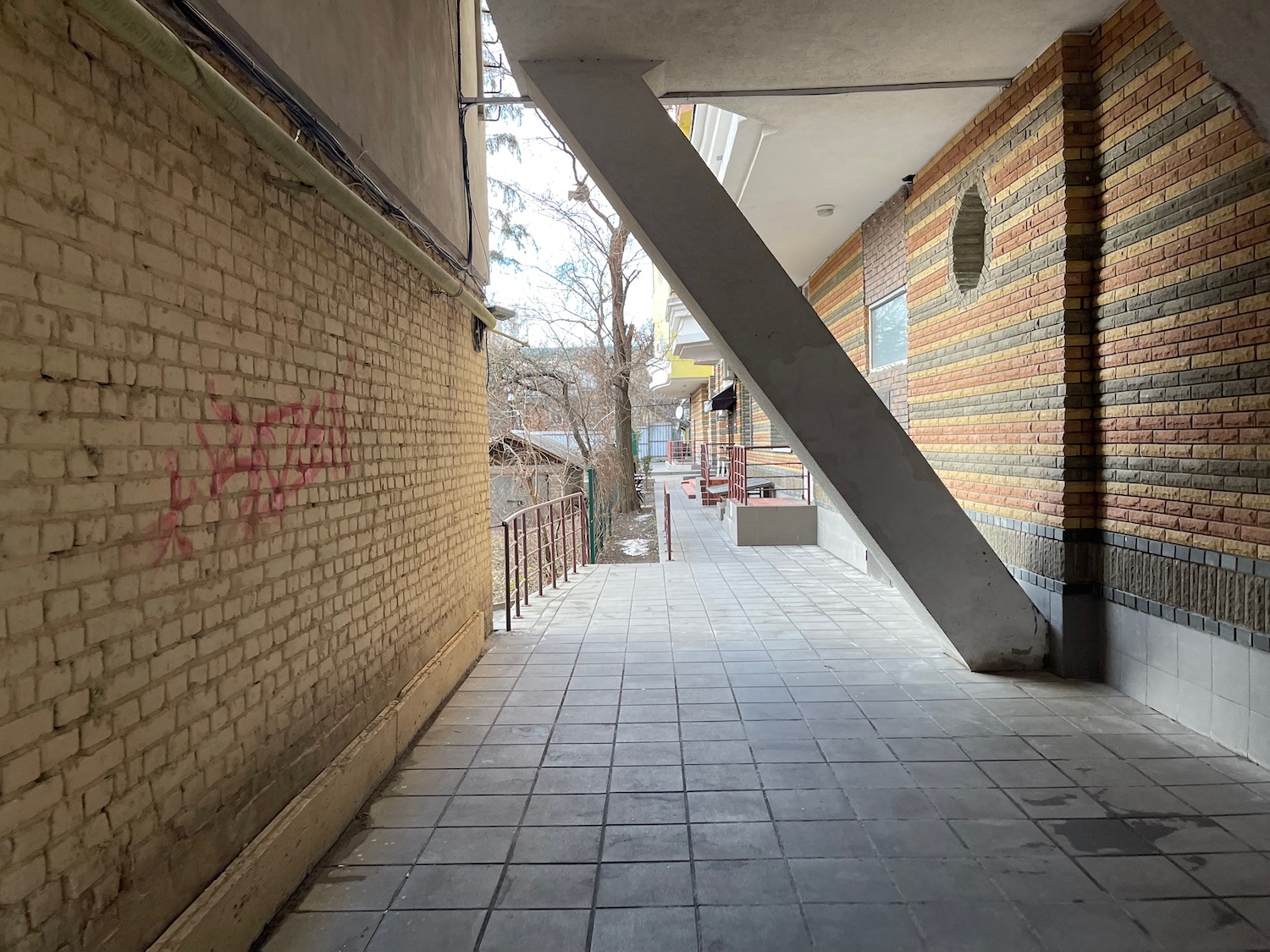 a brick wall with a metal railing