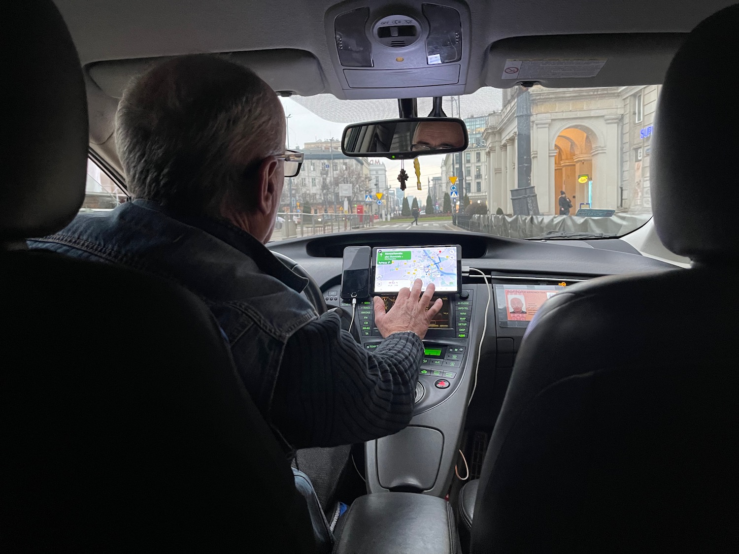 a man in a car using a touch screen device