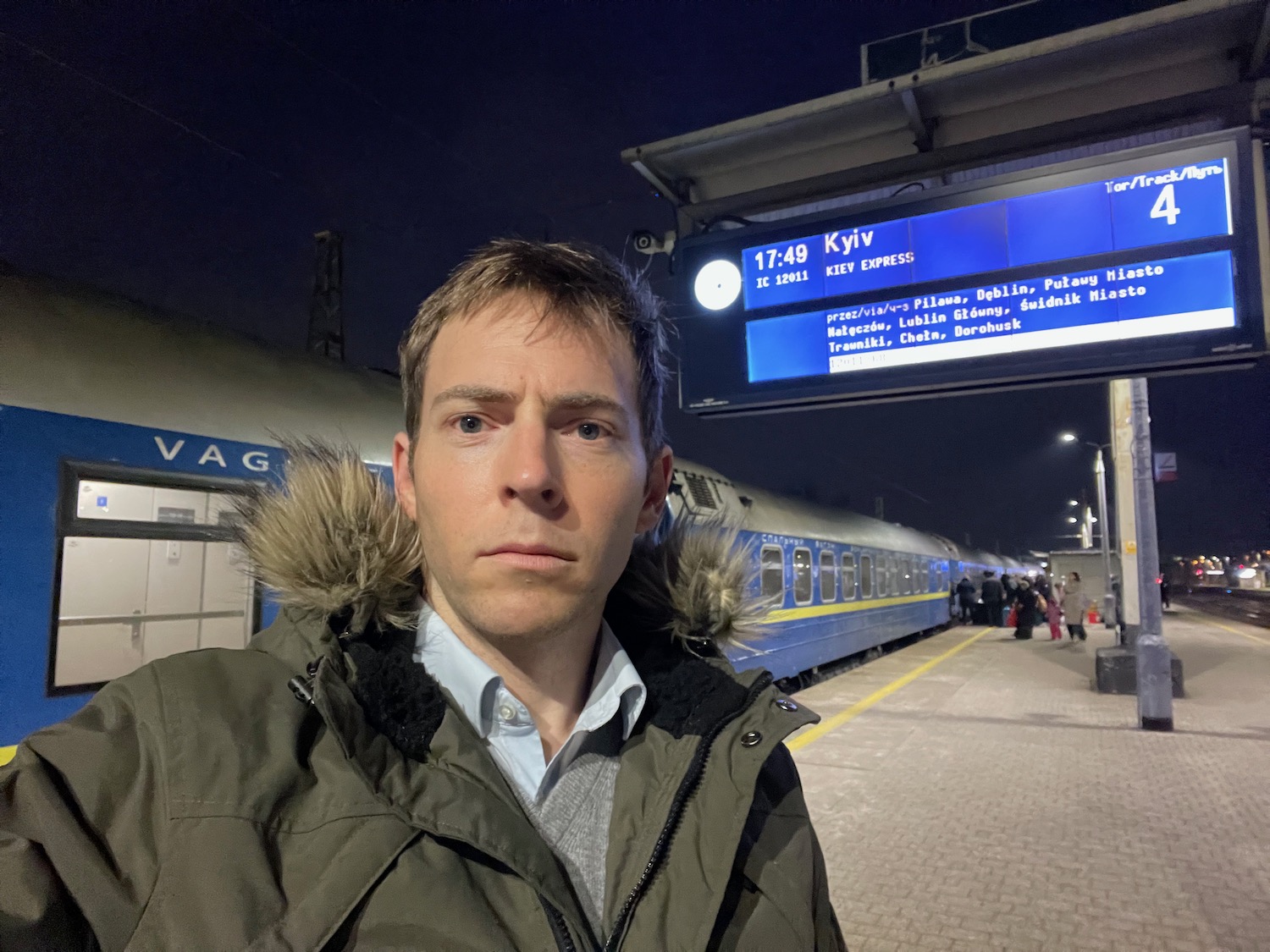 a man taking a selfie at a train station