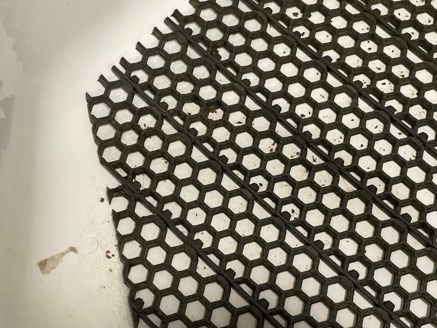 a black grate on a white surface