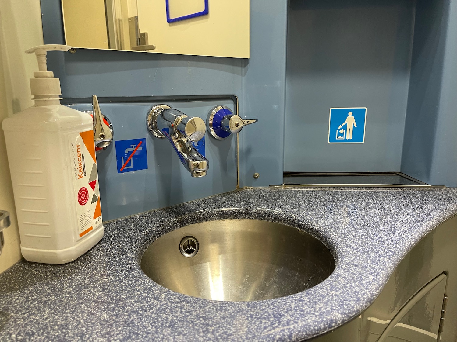 a sink with a bottle of soap and a bottle of liquid