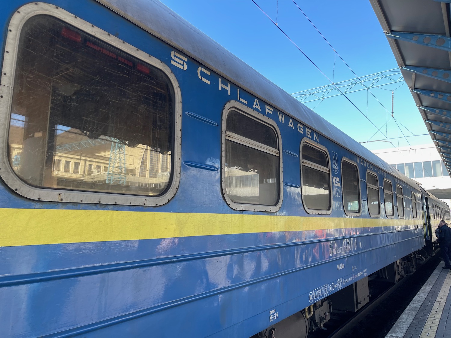 a blue train with yellow stripe