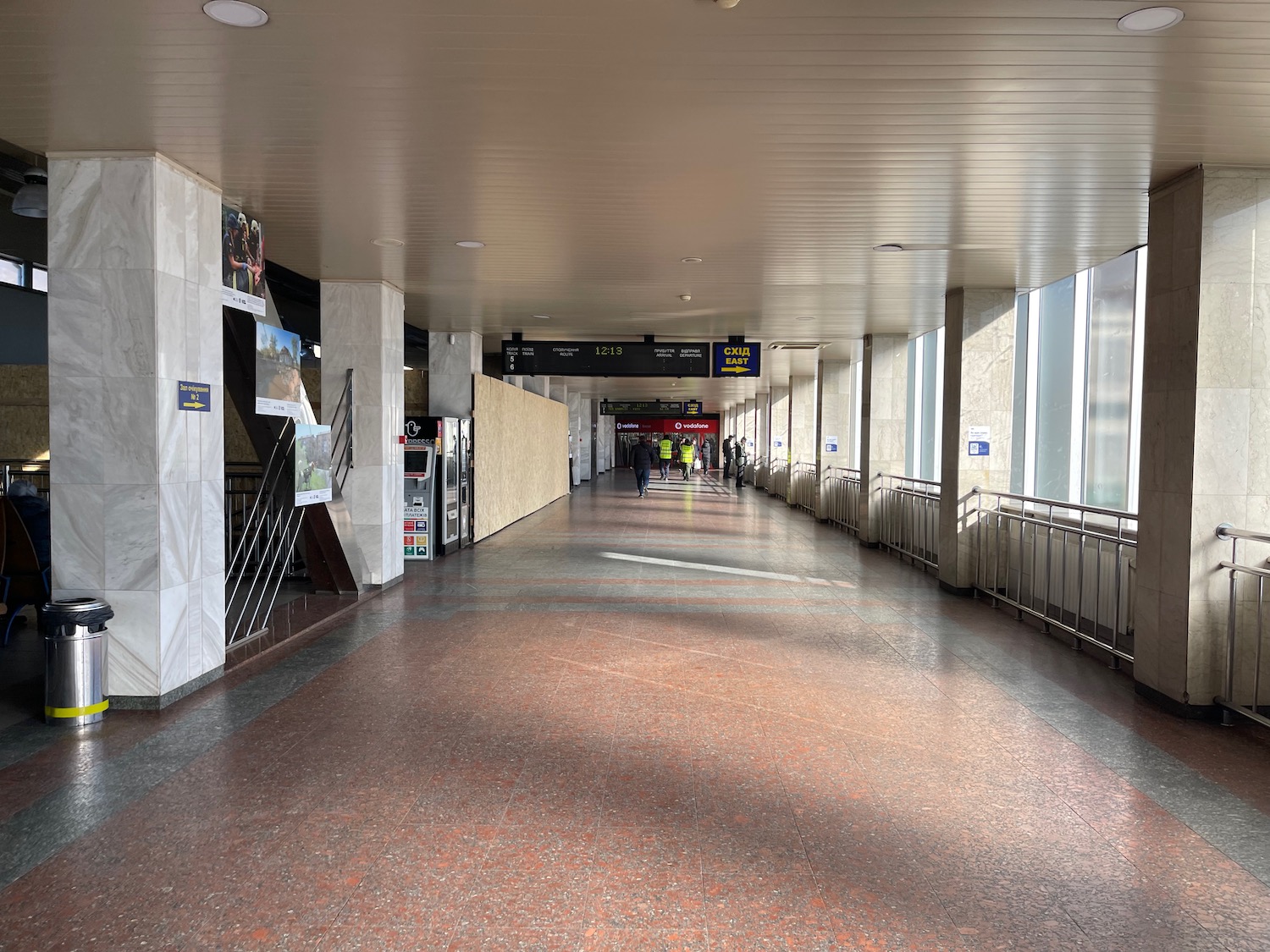 a long hallway with people walking in it