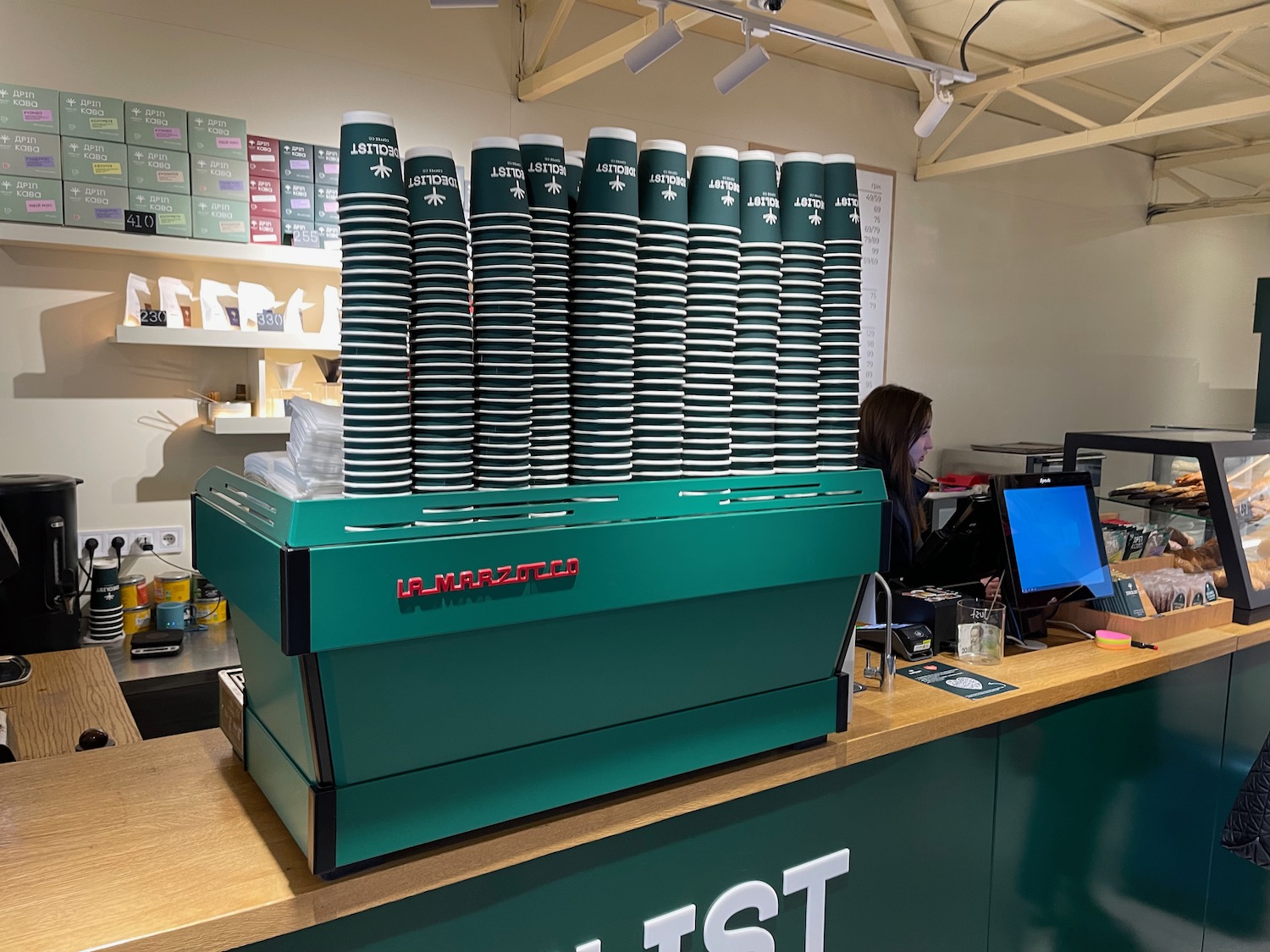 a green coffee cups stacked on top of a counter