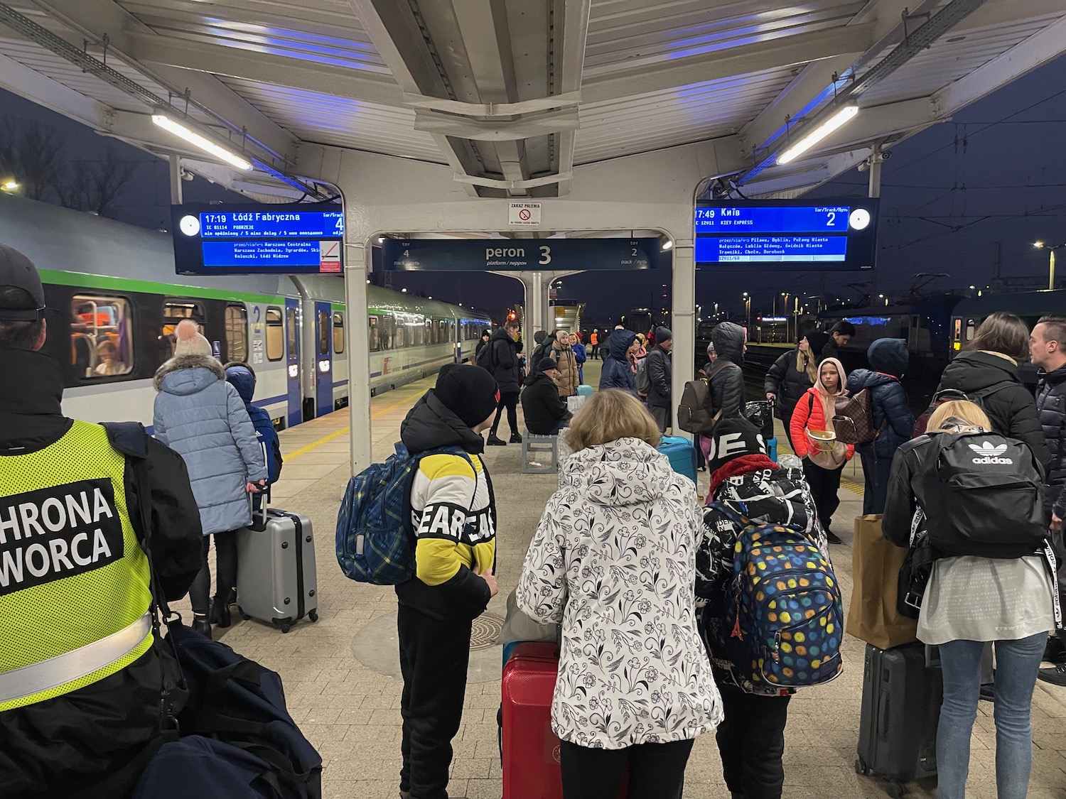 a group of people standing in a train station