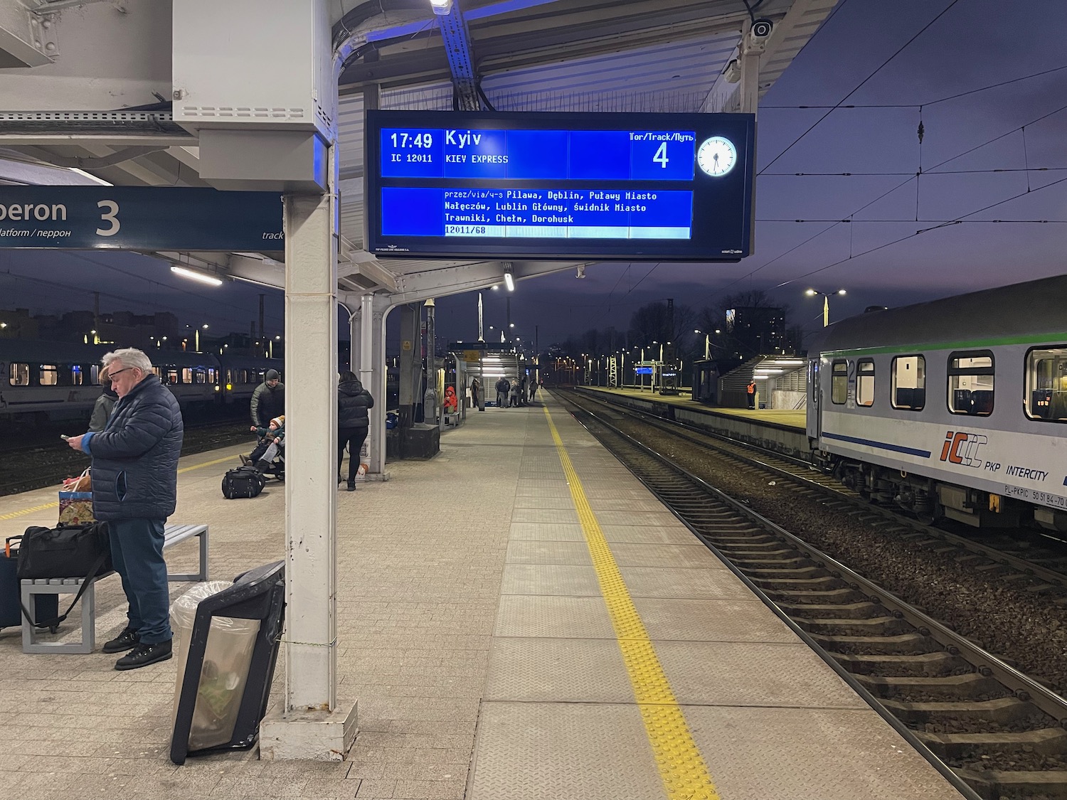 a train station with a digital sign