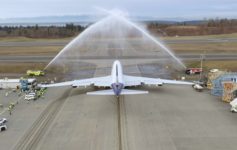 a jet plane spraying water on runway