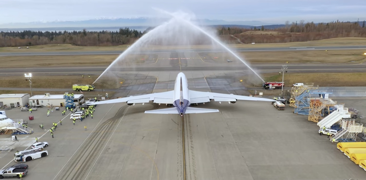 a jet plane spraying water on runway