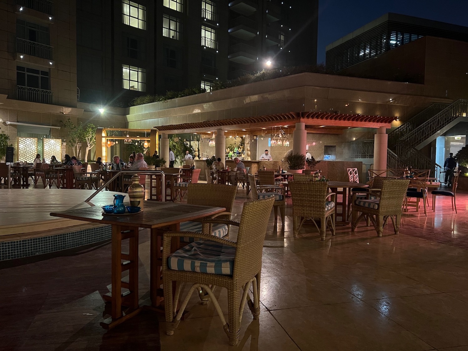 a restaurant with tables and chairs outside at night