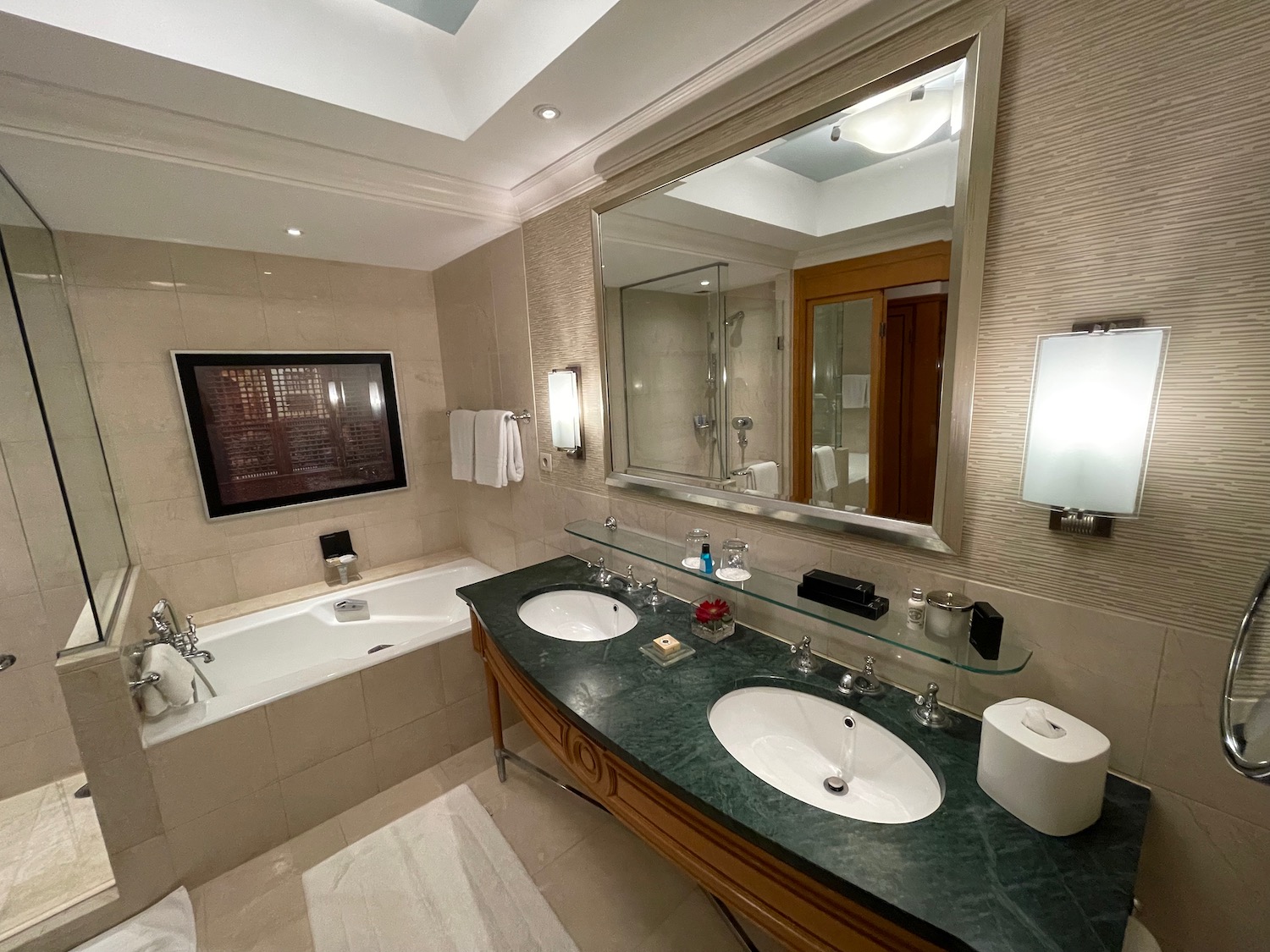 a bathroom with a large mirror and a tub