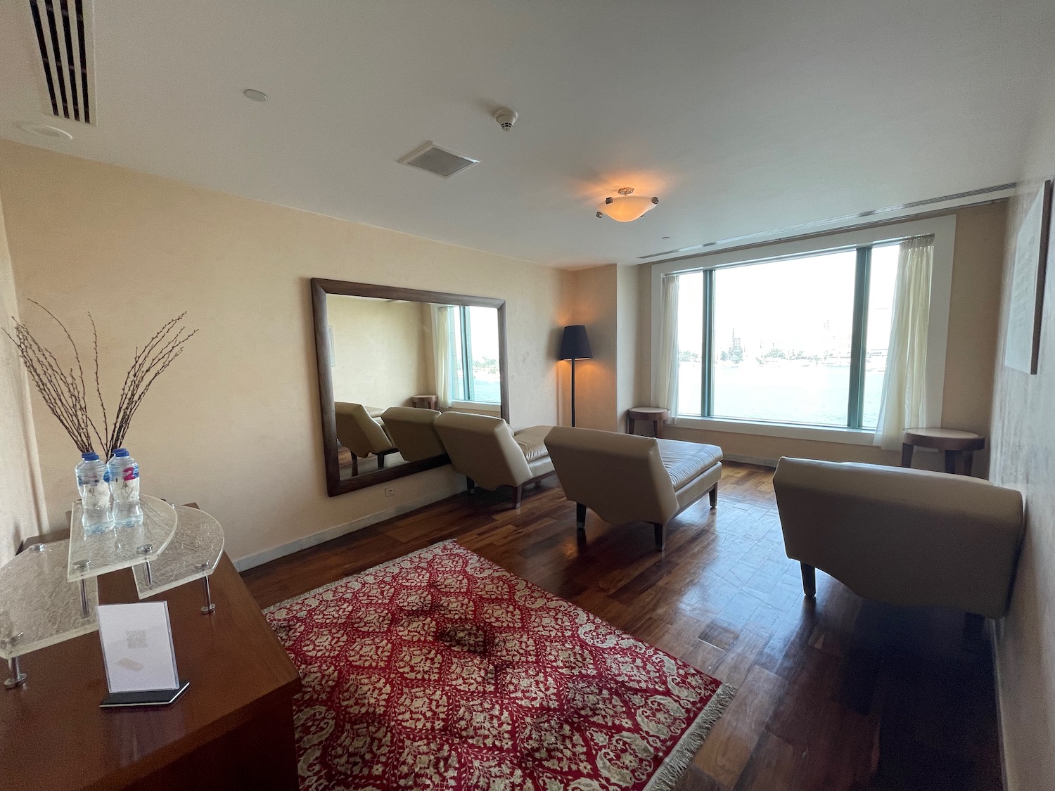 a room with a red rug and chairs