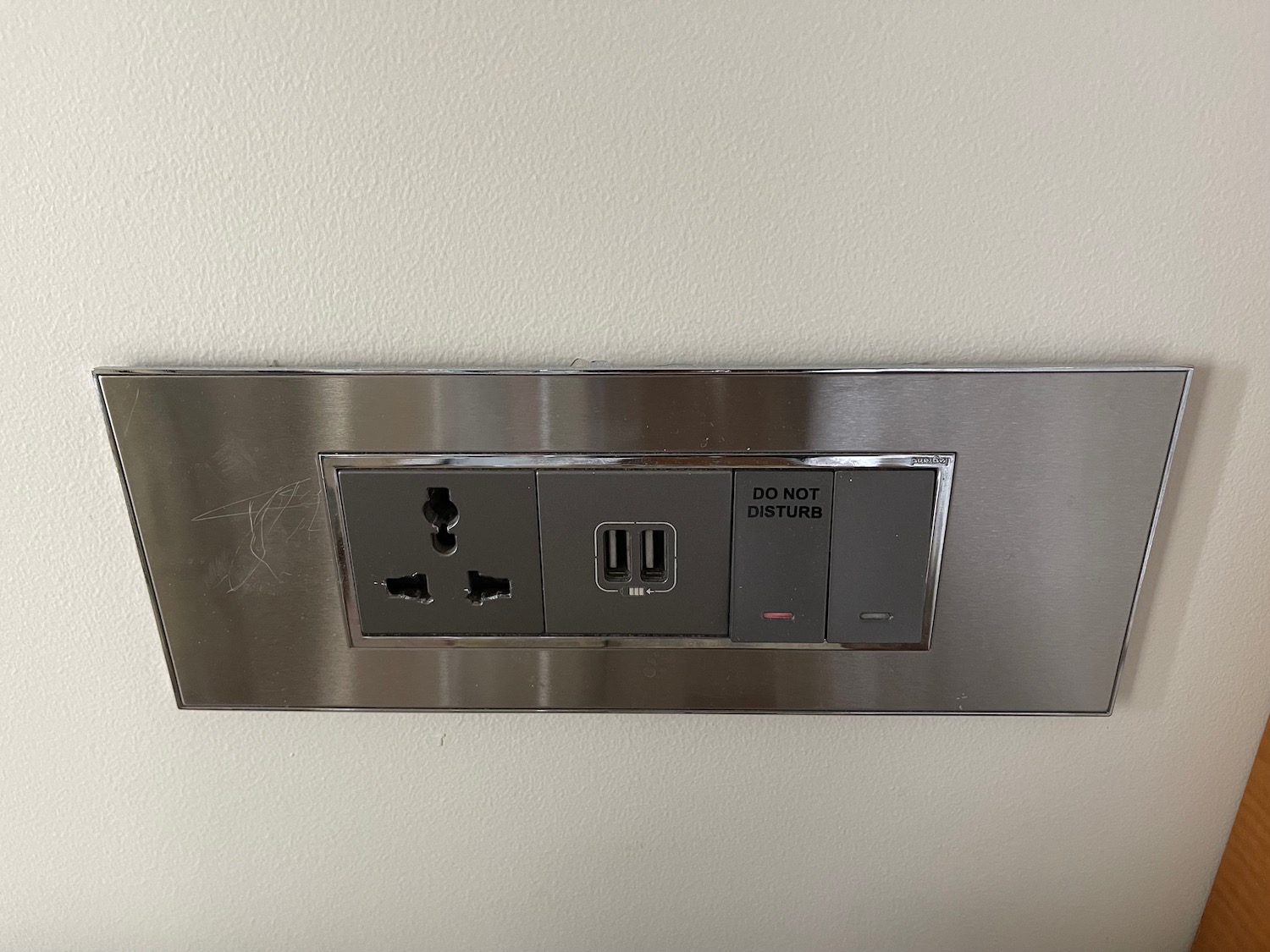 a silver rectangular outlet with a black and white button