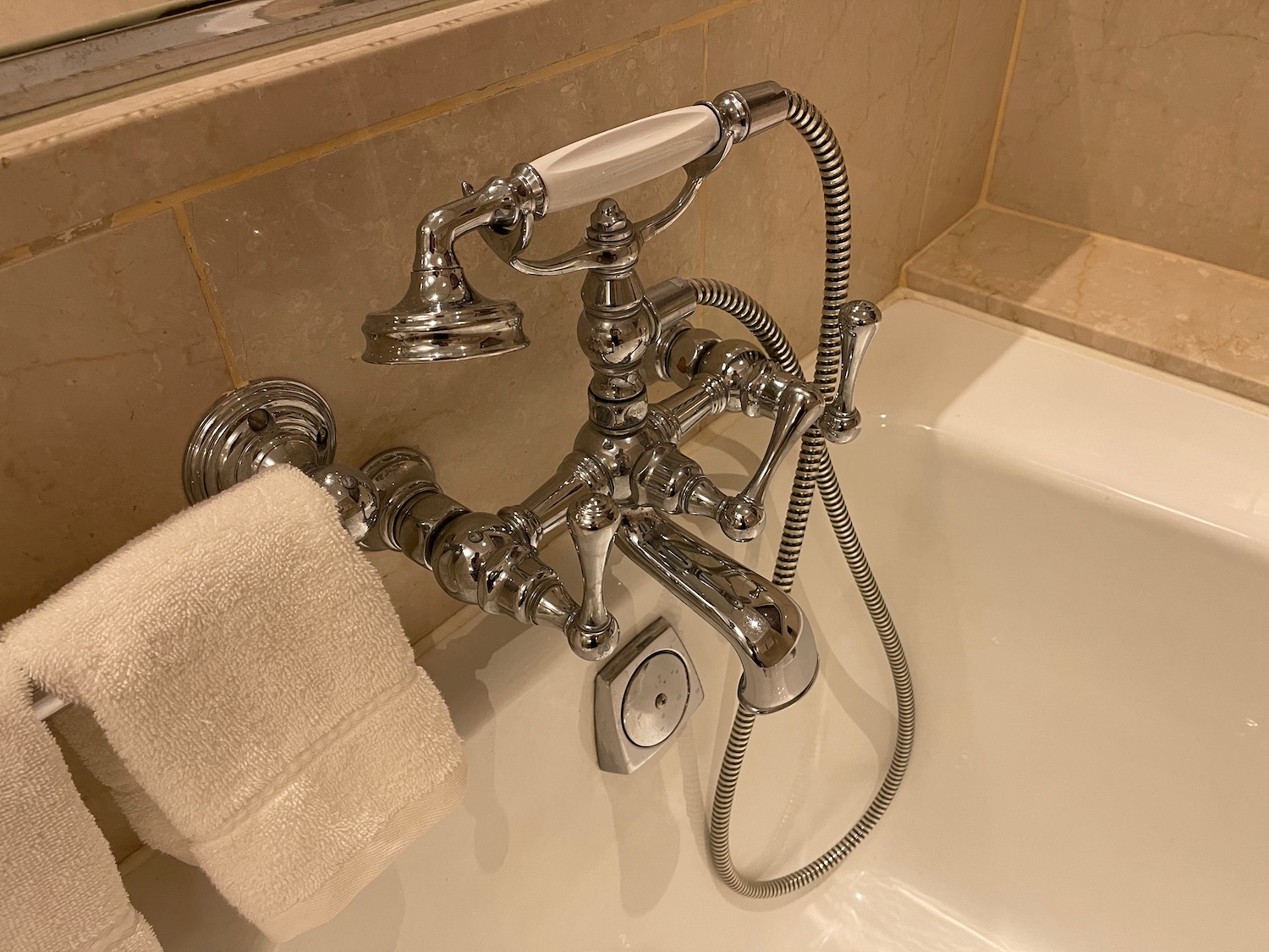 a bathtub with a faucet and a towel