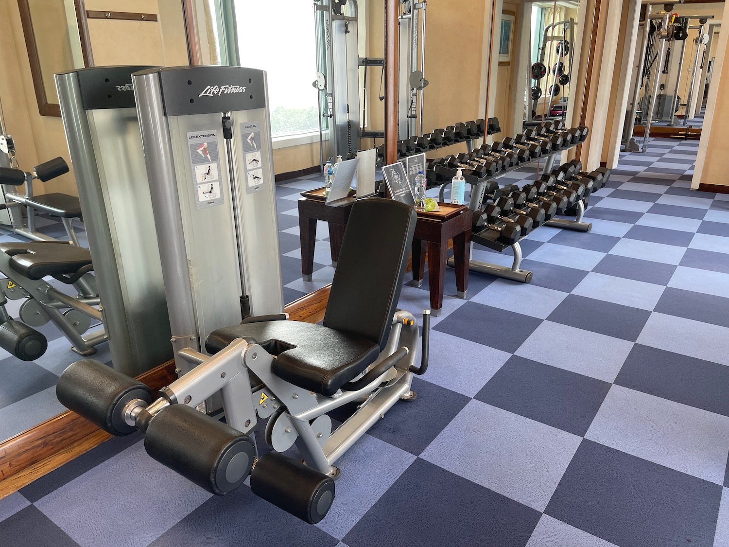 a gym with weights and a bench