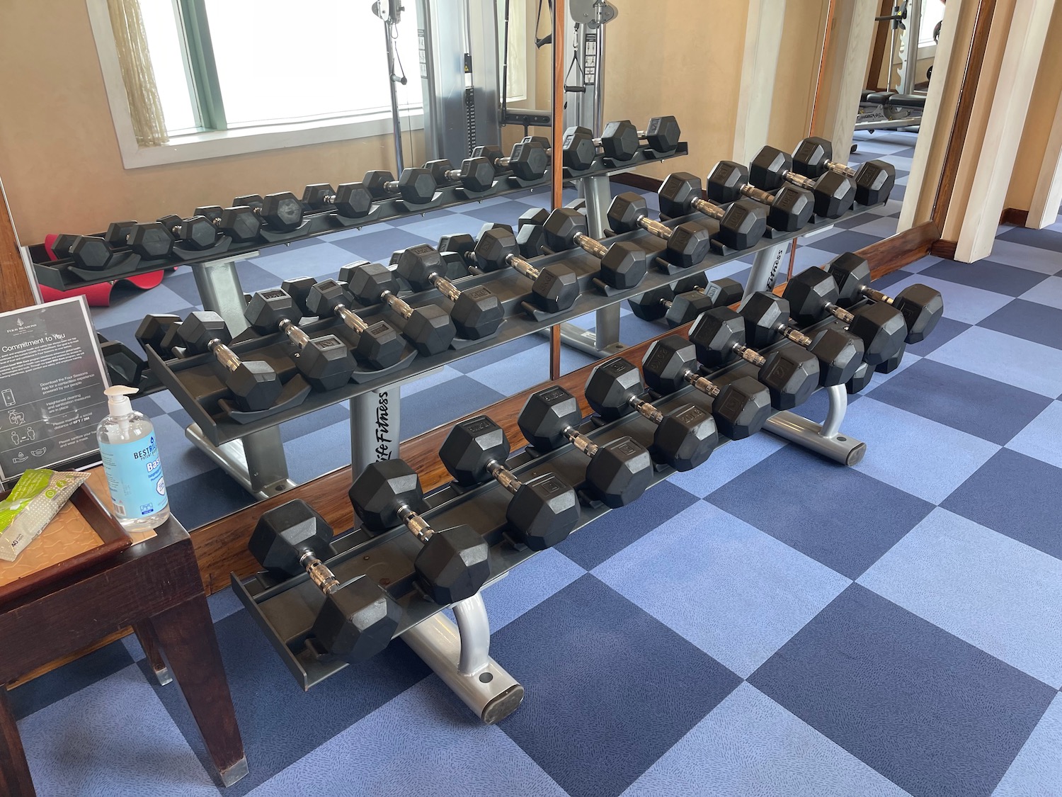 a row of dumbbells in a gym