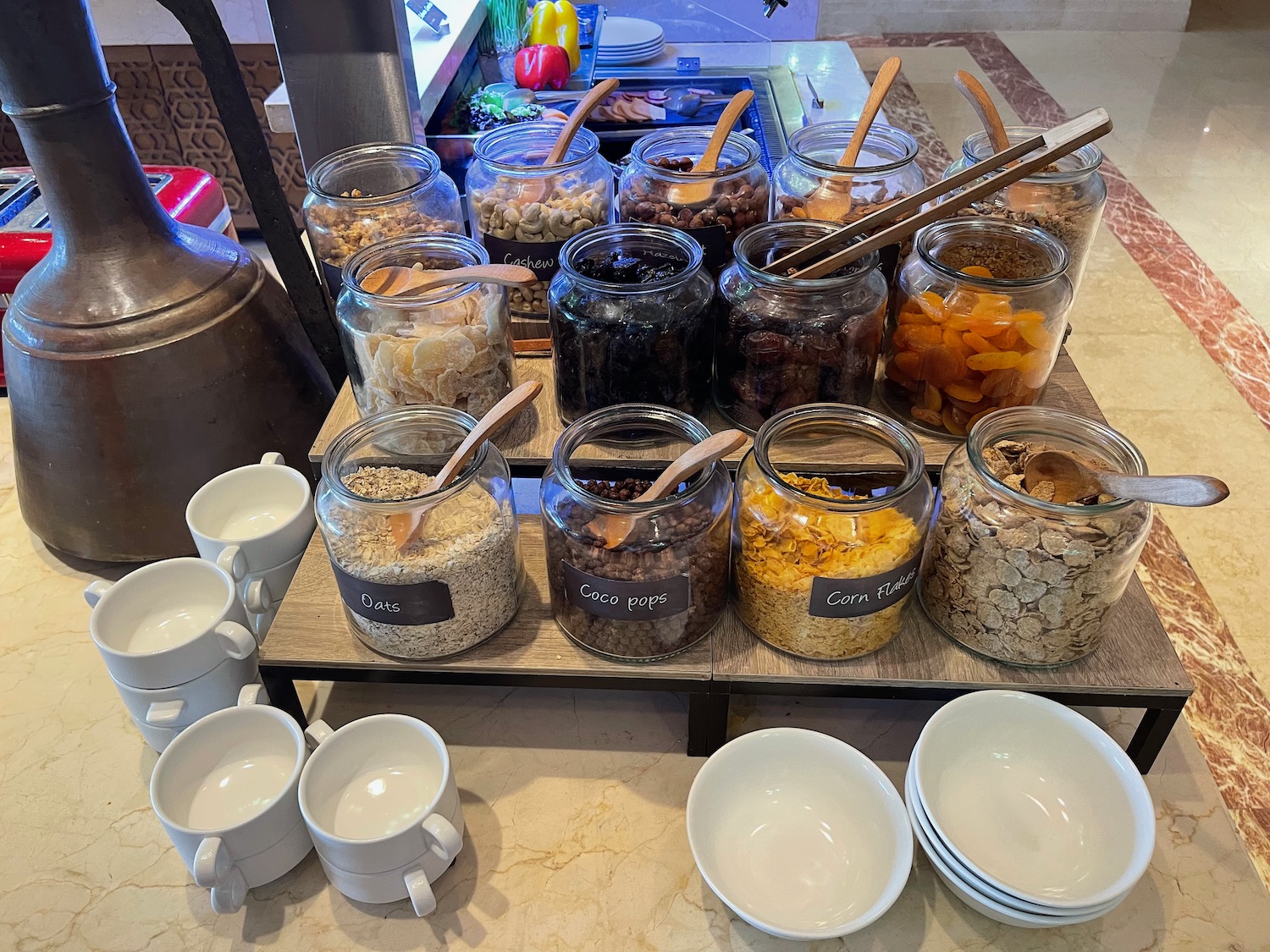 a group of glass jars with food on a table