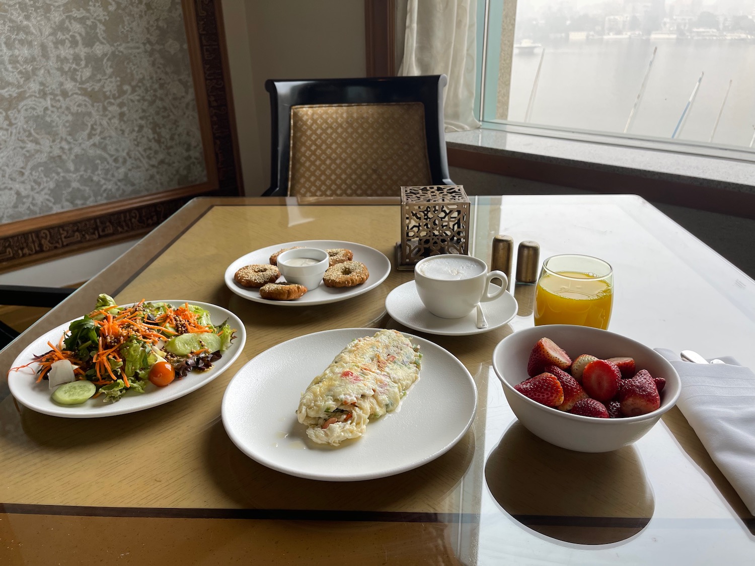 a table with plates of food and drinks